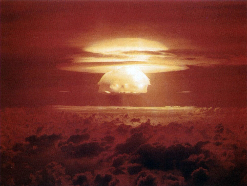Eksplozja Castle Bravo (1954, 15 Mt) — pierwsza praktyczna „sucha" bomba Teller-Ulam, w której implozja radiacyjna ścisnęła stałe paliwo (deuterek litu). Moc 2,5× większa od przewidywań pokazała, jak potężny jest ten mechanizm. Zdjęcie: Wikimedia Commons